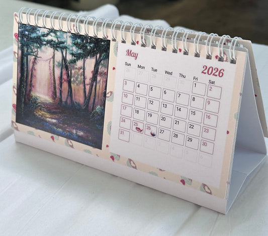 2026 faith-inspired desk calendar open to May, featuring an original forest painting by M. Thompson Art
