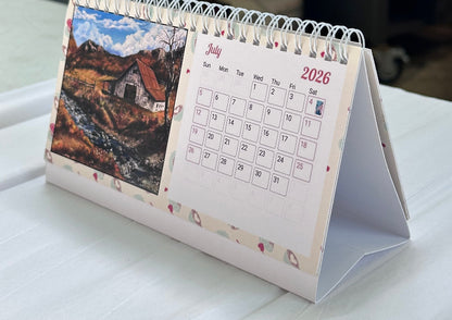 2026 faith-inspired desk calendar open to July, featuring an original forest painting by M. Thompson Art
