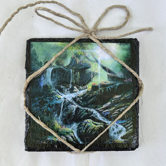 Decorative coaster with nature-themed waterfall design tied with twine on a white background                                                                                                      